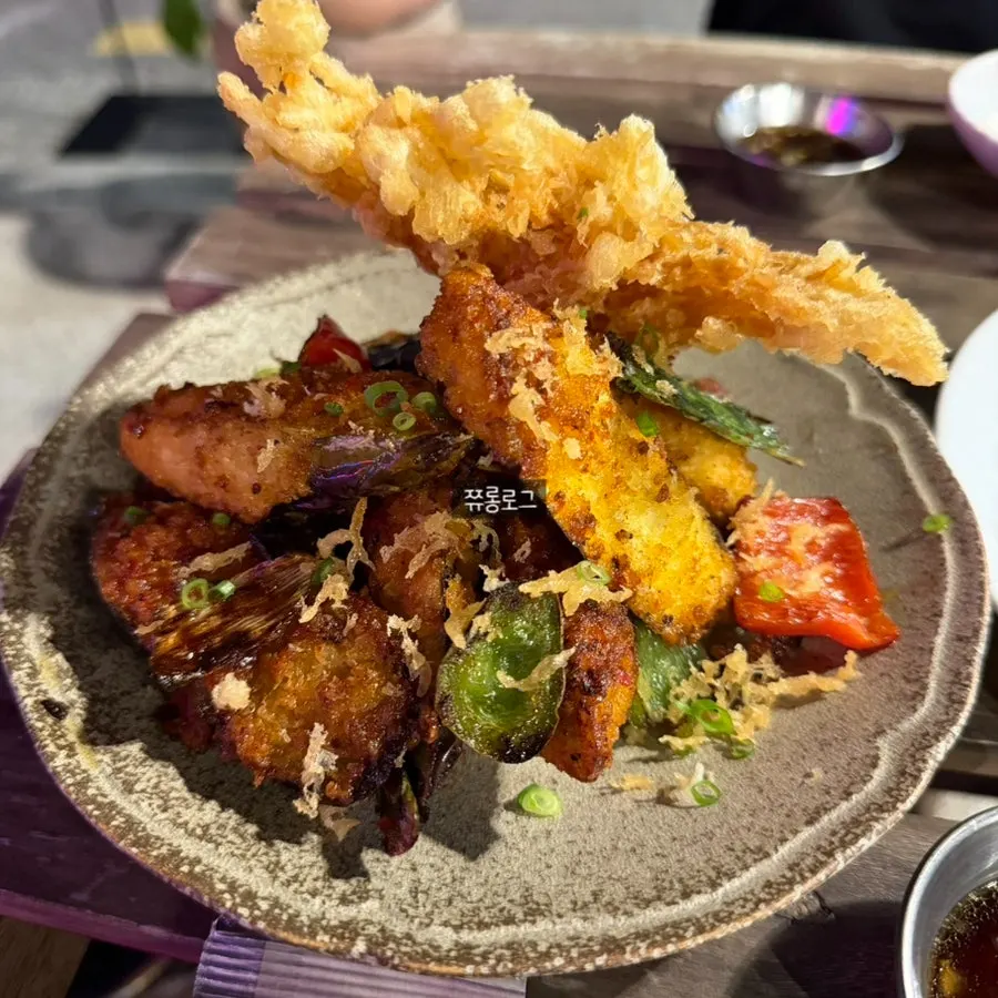 Raw shrimp sashimi and eggplant fritters set out on the outdoor table