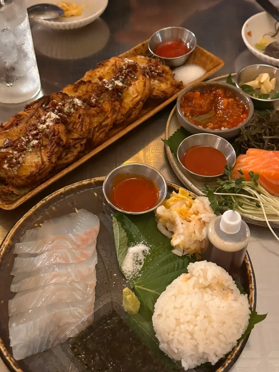 A patio table full of various dishes