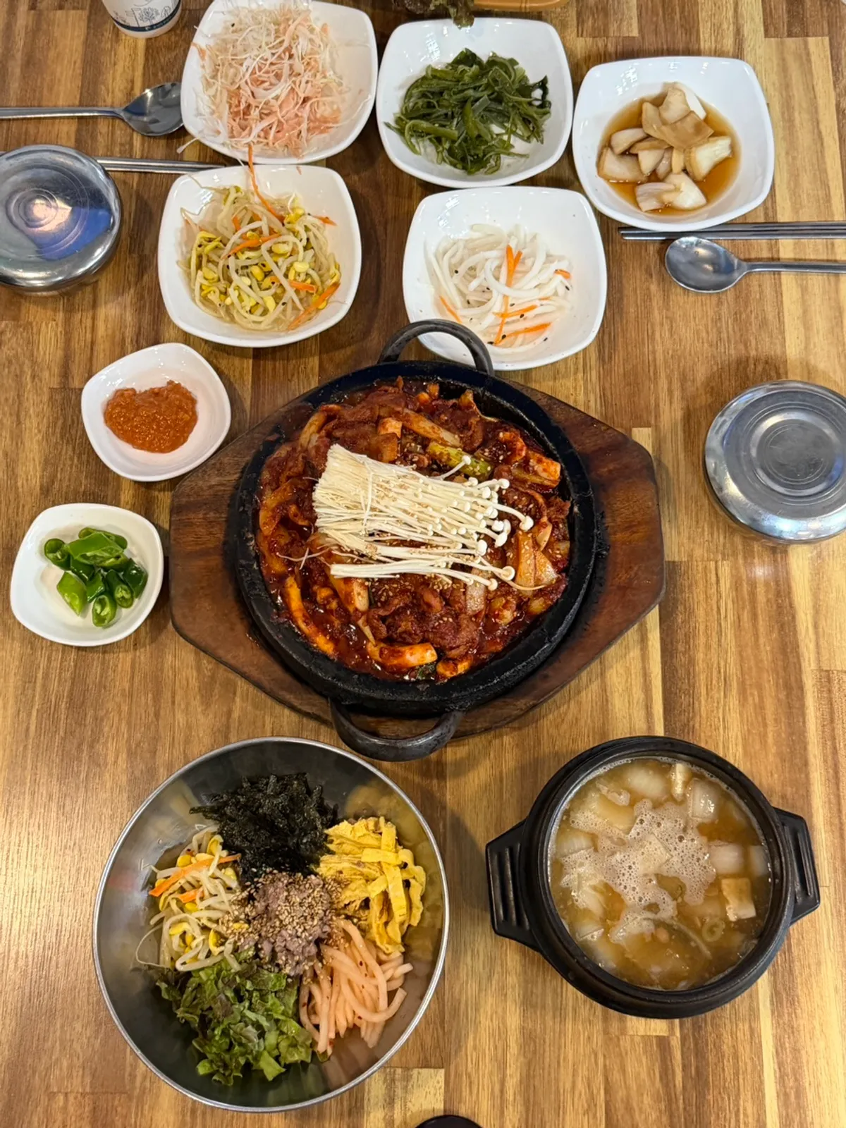 Stone-grilled squid-pork stir-fry and bibimbap spread