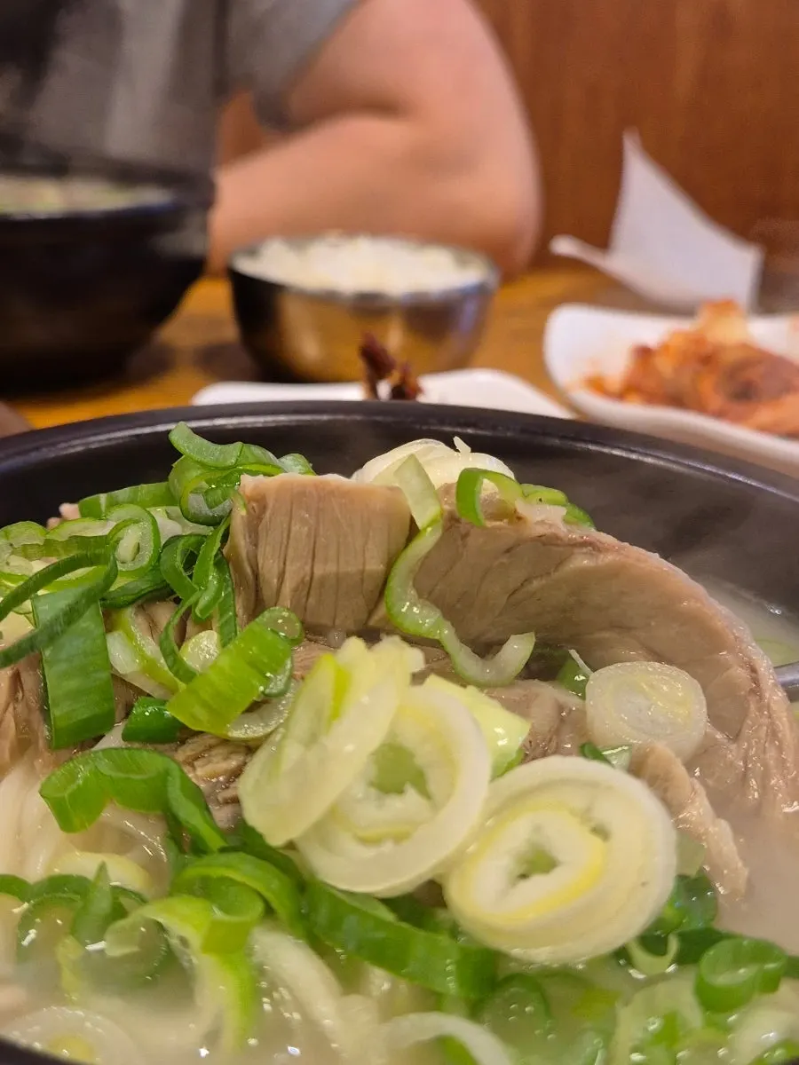 A stone bowl of special seolleongtang piled high with meat