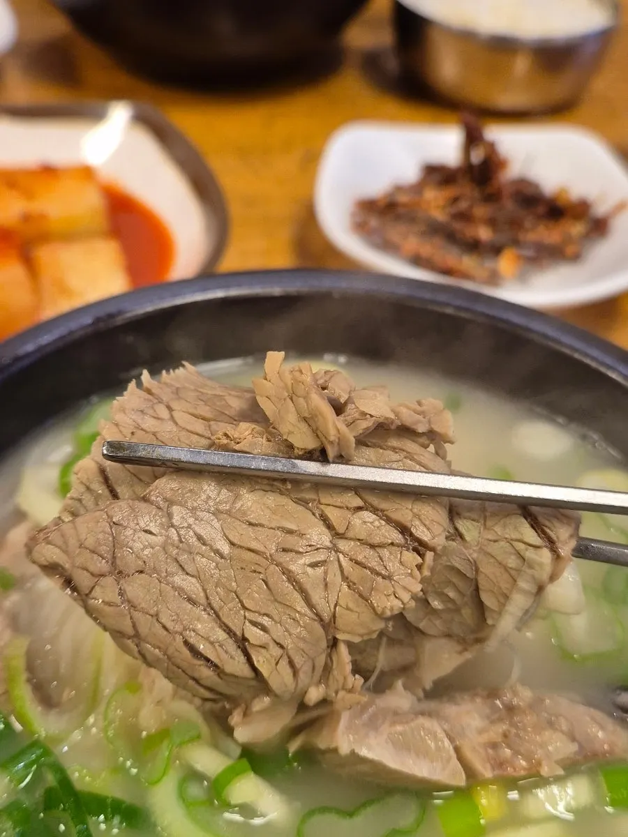 Seolleongtang broth topped with noodles and scallions