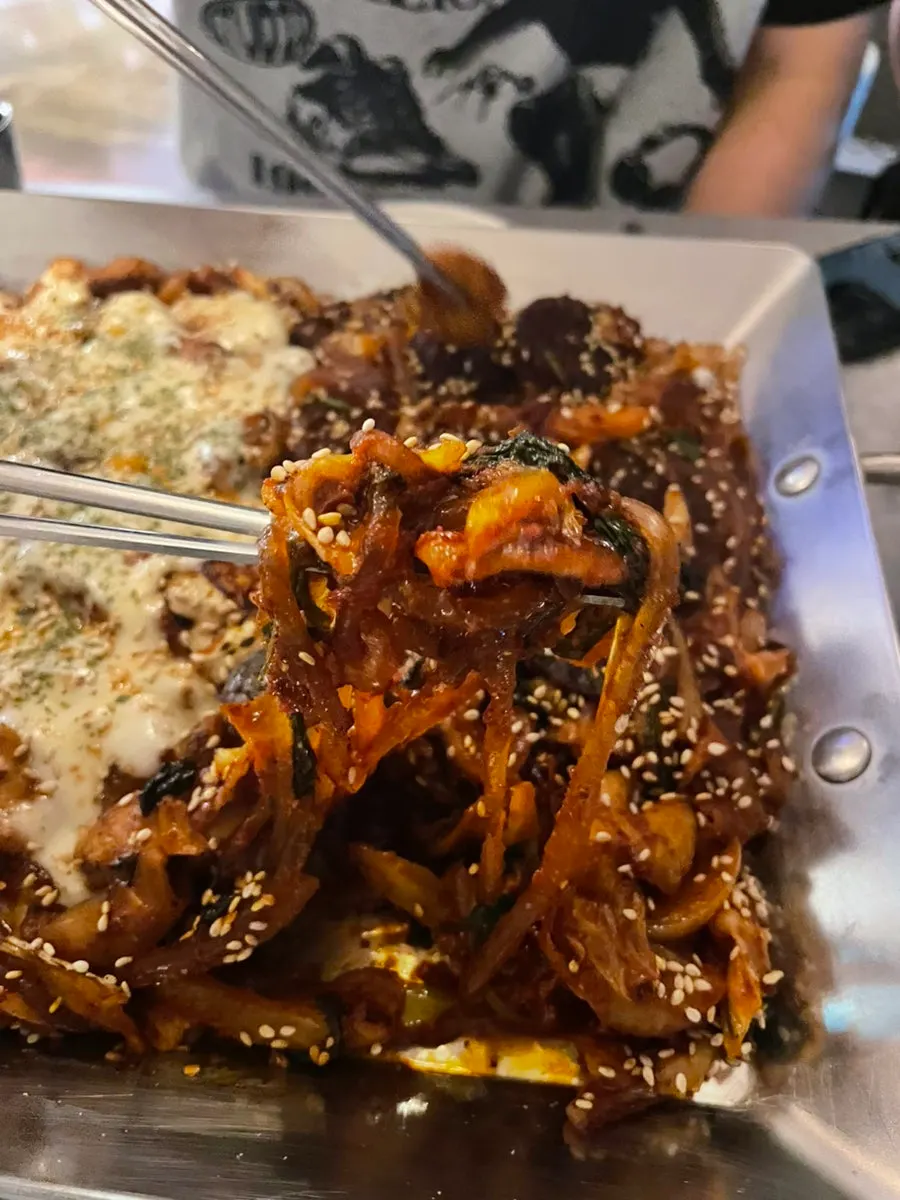Close-up of vegetable gopchang loaded with cabbage and perilla leaves