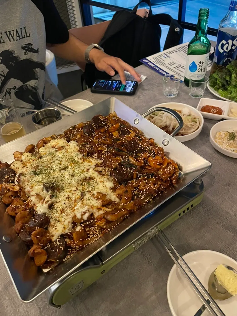 Vegetable gopchang table spread served alongside drinks