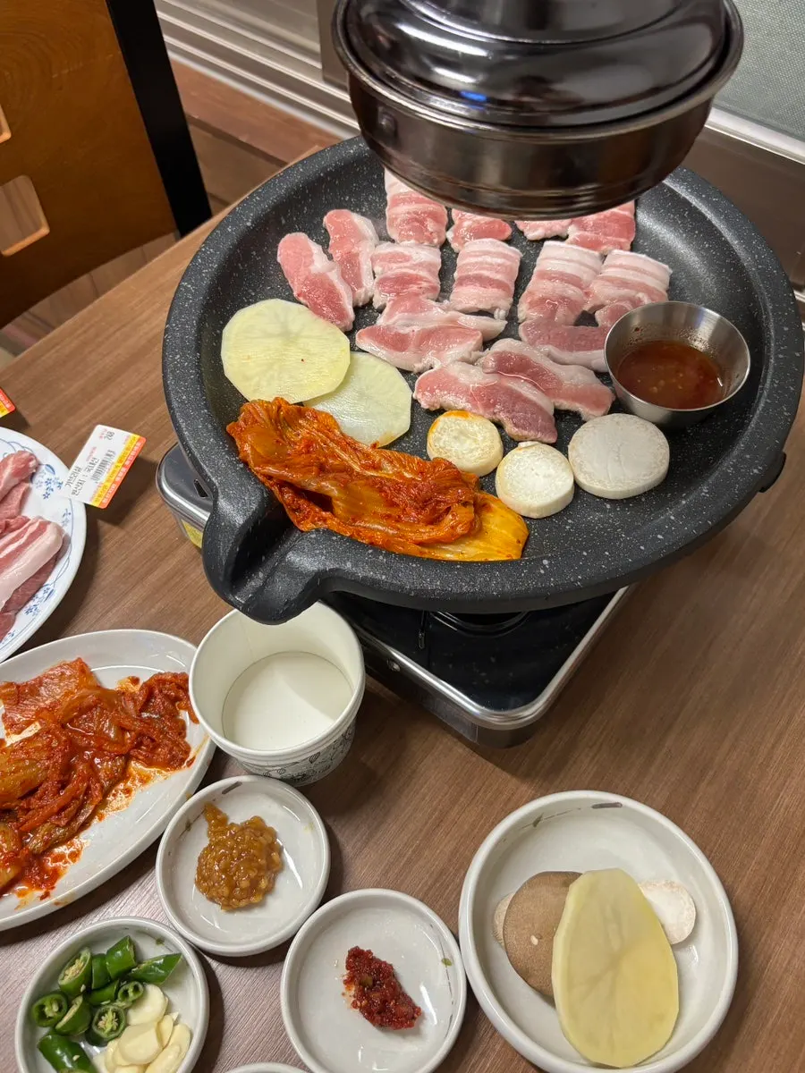 Stir-fried kimchi and a stone griddle for grilling pork