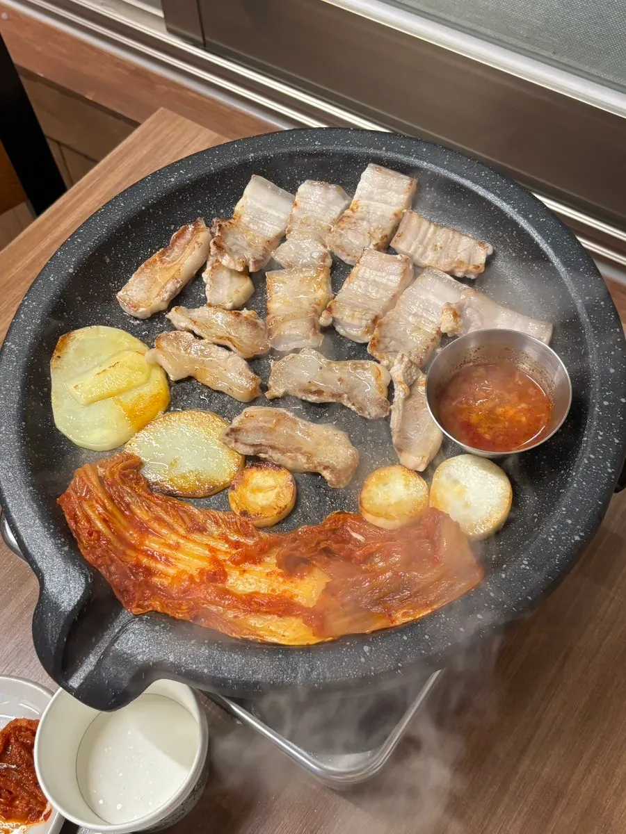 Pork and accompaniments on a stone griddle