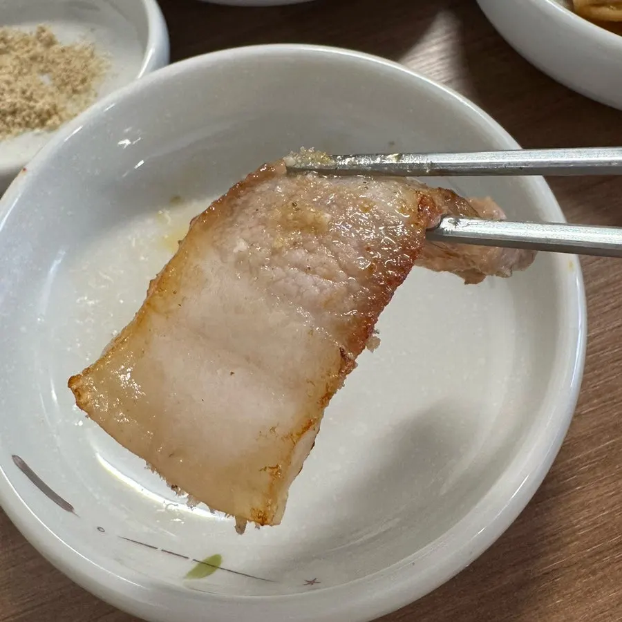 Pork belly and pork jowl cooking on the grill