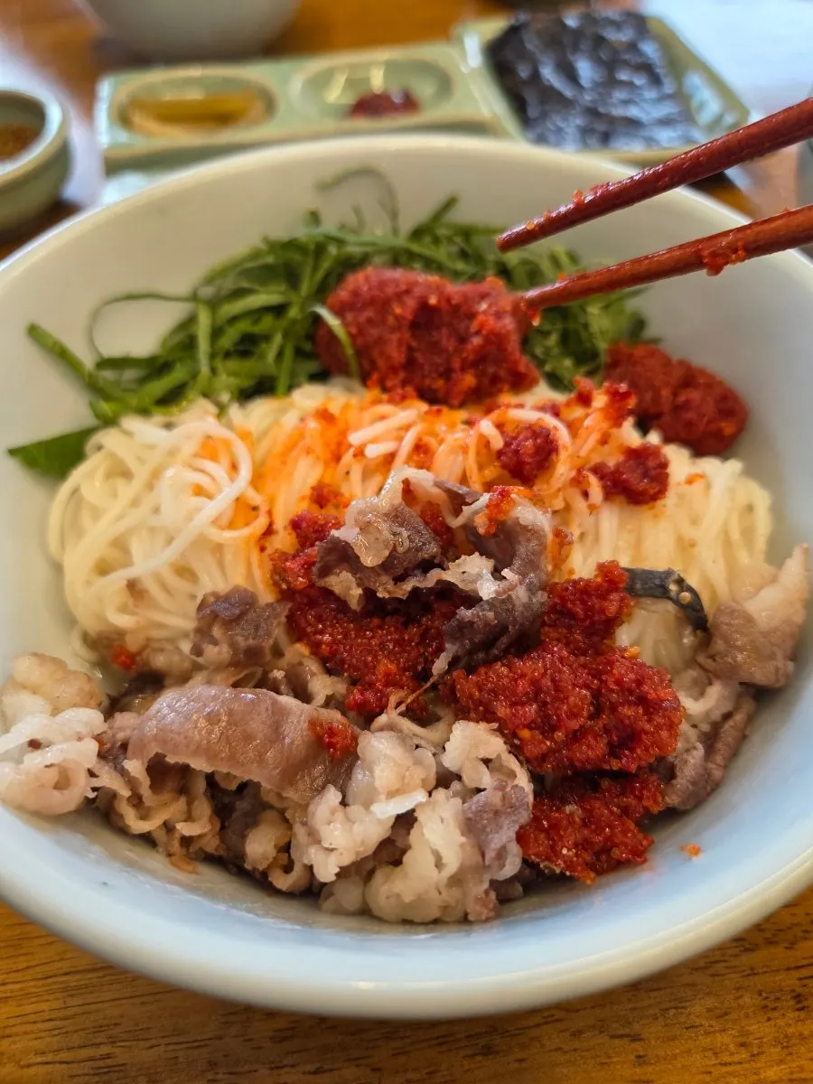 Bibim noodles topped with herring roe and beef brisket