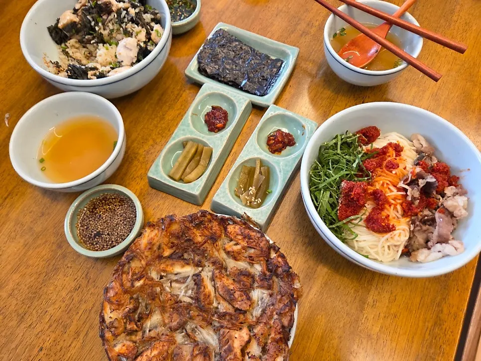 A spread of herring roe bibim noodles and side dishes