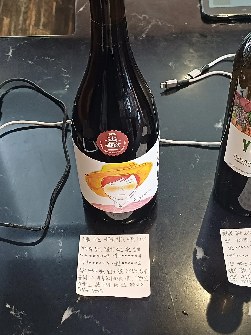 A wine bottle with a handwritten description at Dento