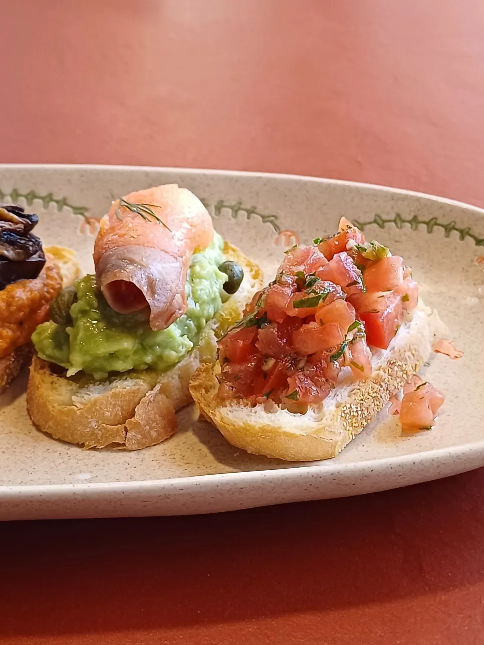 Five bite-size open sandwiches arranged on a plate