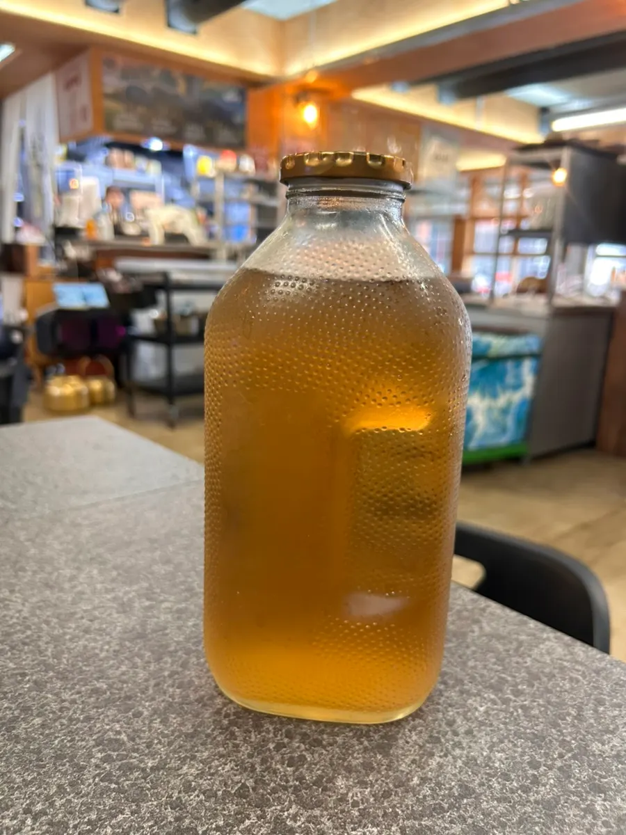 Retro orange juice bottle filled with barley tea