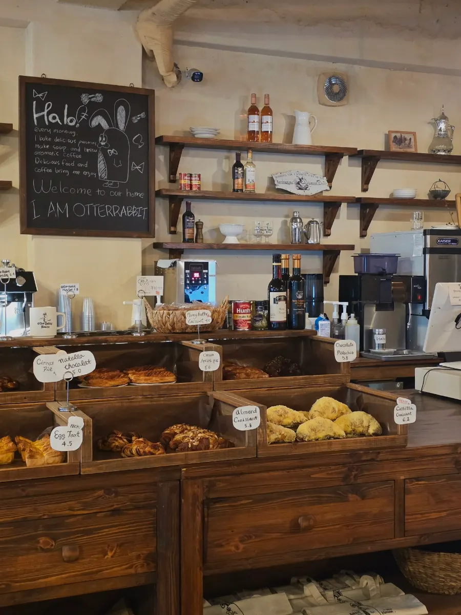 An assortment of breads displayed on one side of the café