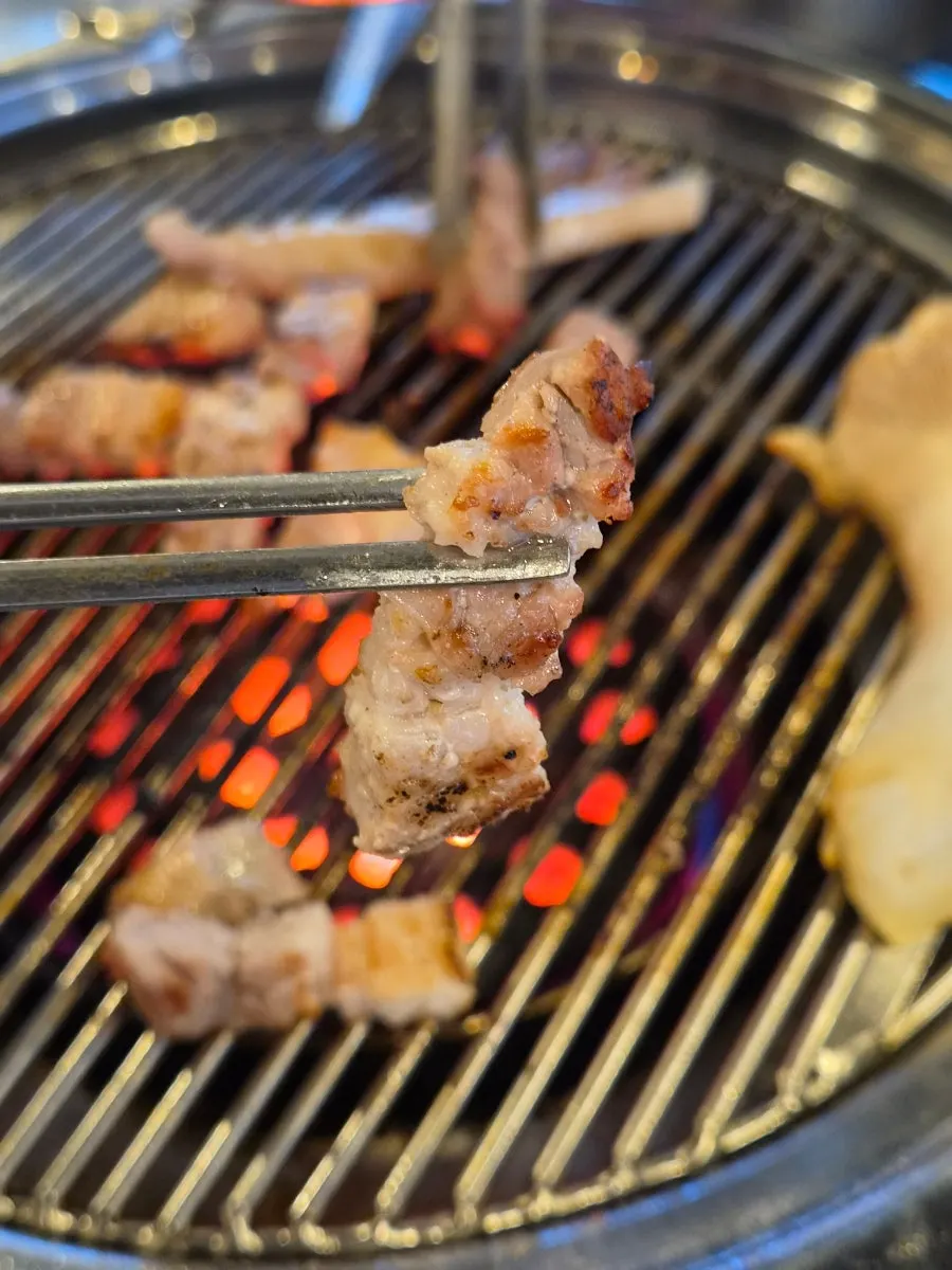 Samgyeopsal cooking over charcoal fire