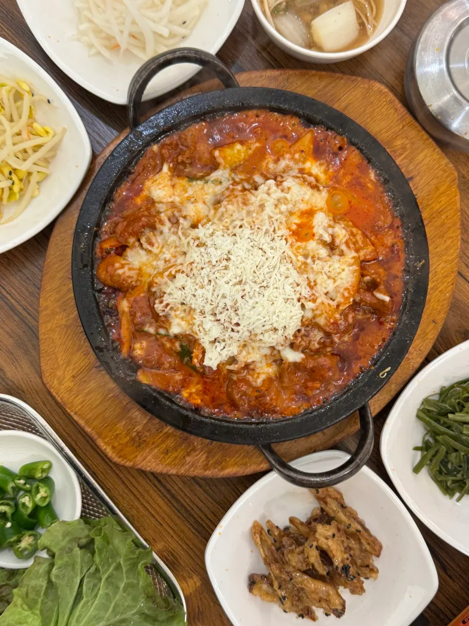 Spicy creamy pork on a stone plate topped with cheese