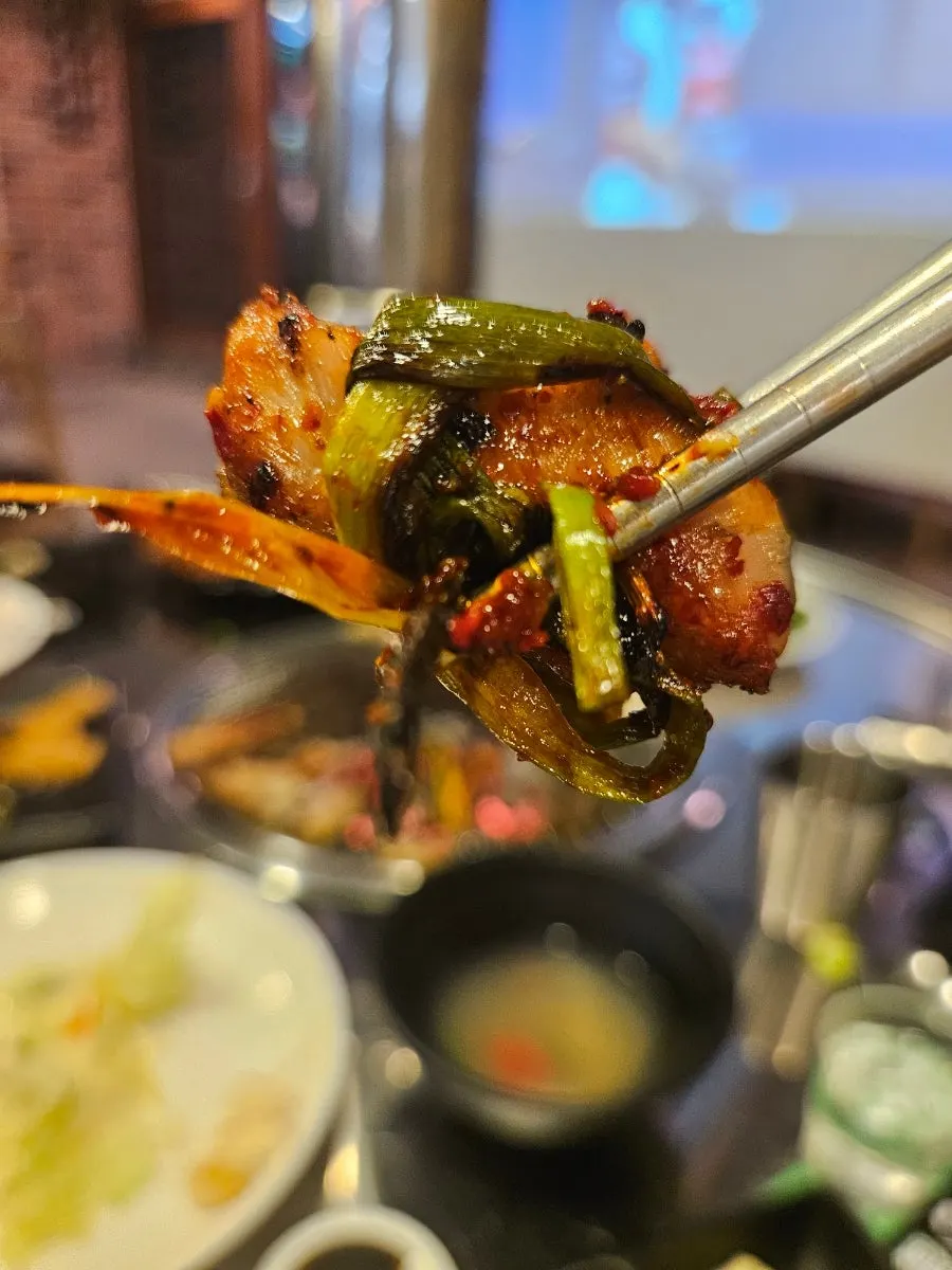 Pale, well-cooked salt-grilled chicken over charcoal