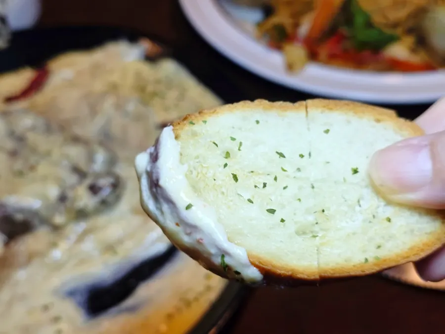 A piece of steak dipped into the cream sauce