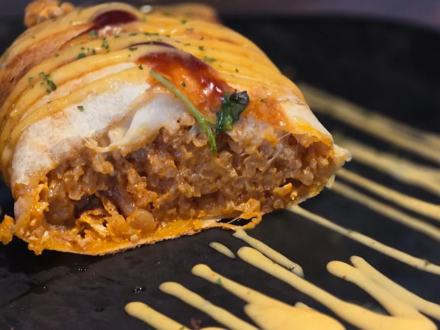 Cross-section of baked risotto with sauce
