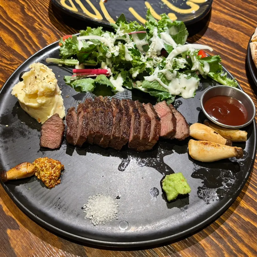 Flat iron steak served with salad