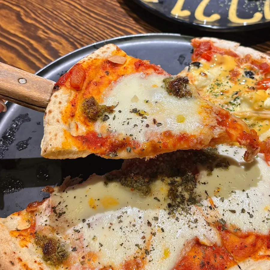 Margherita pizza topped with tomato sauce