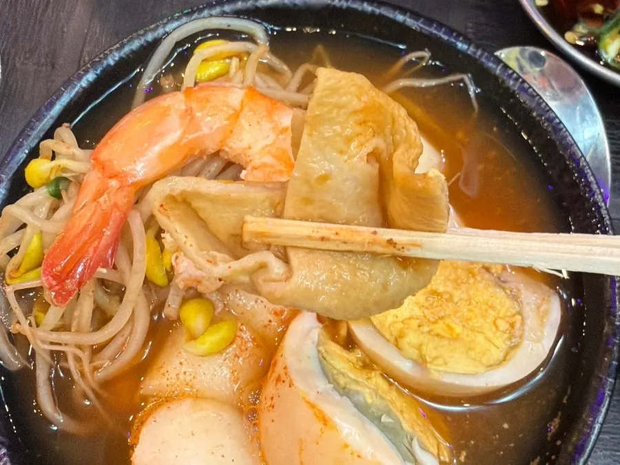 A plate of seafood fish cake broth and ingredients