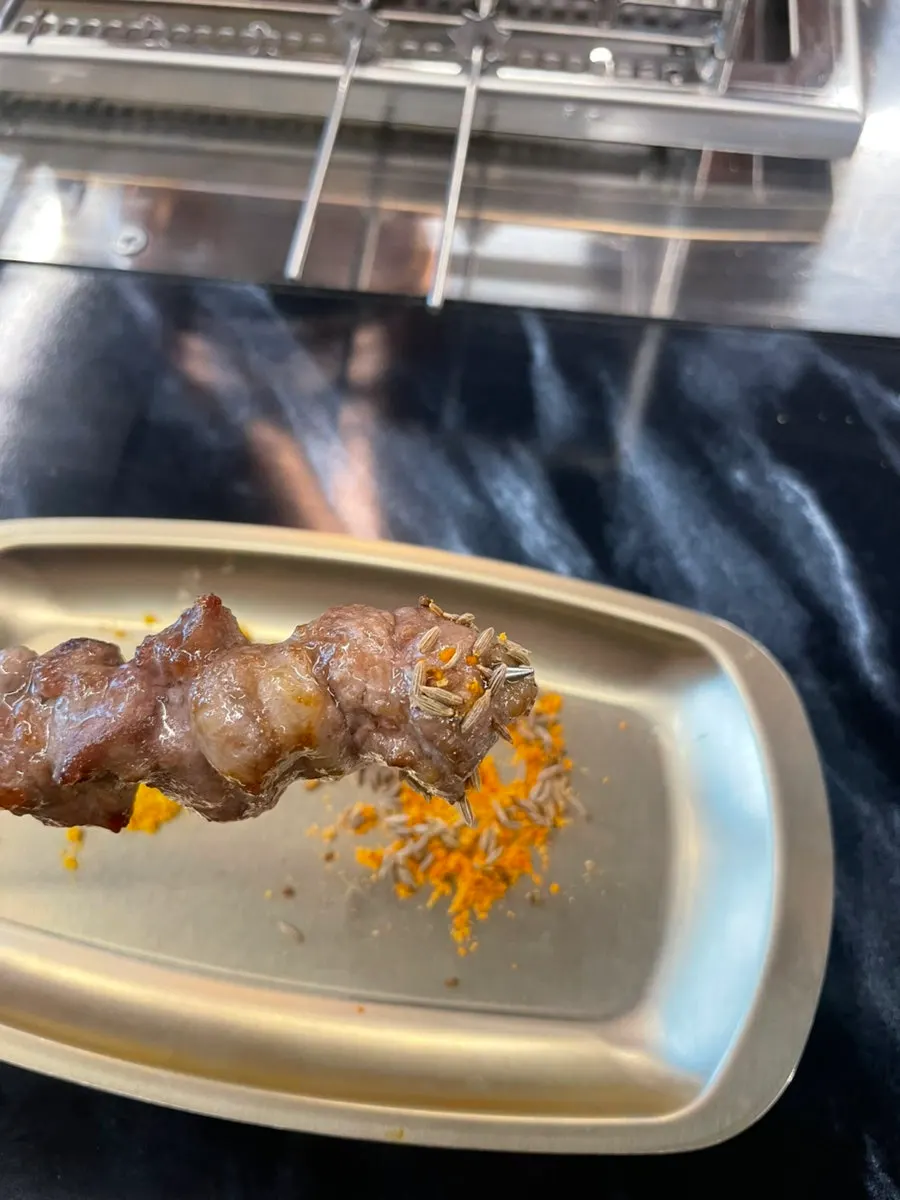 Lamb skewers dipped in curry powder