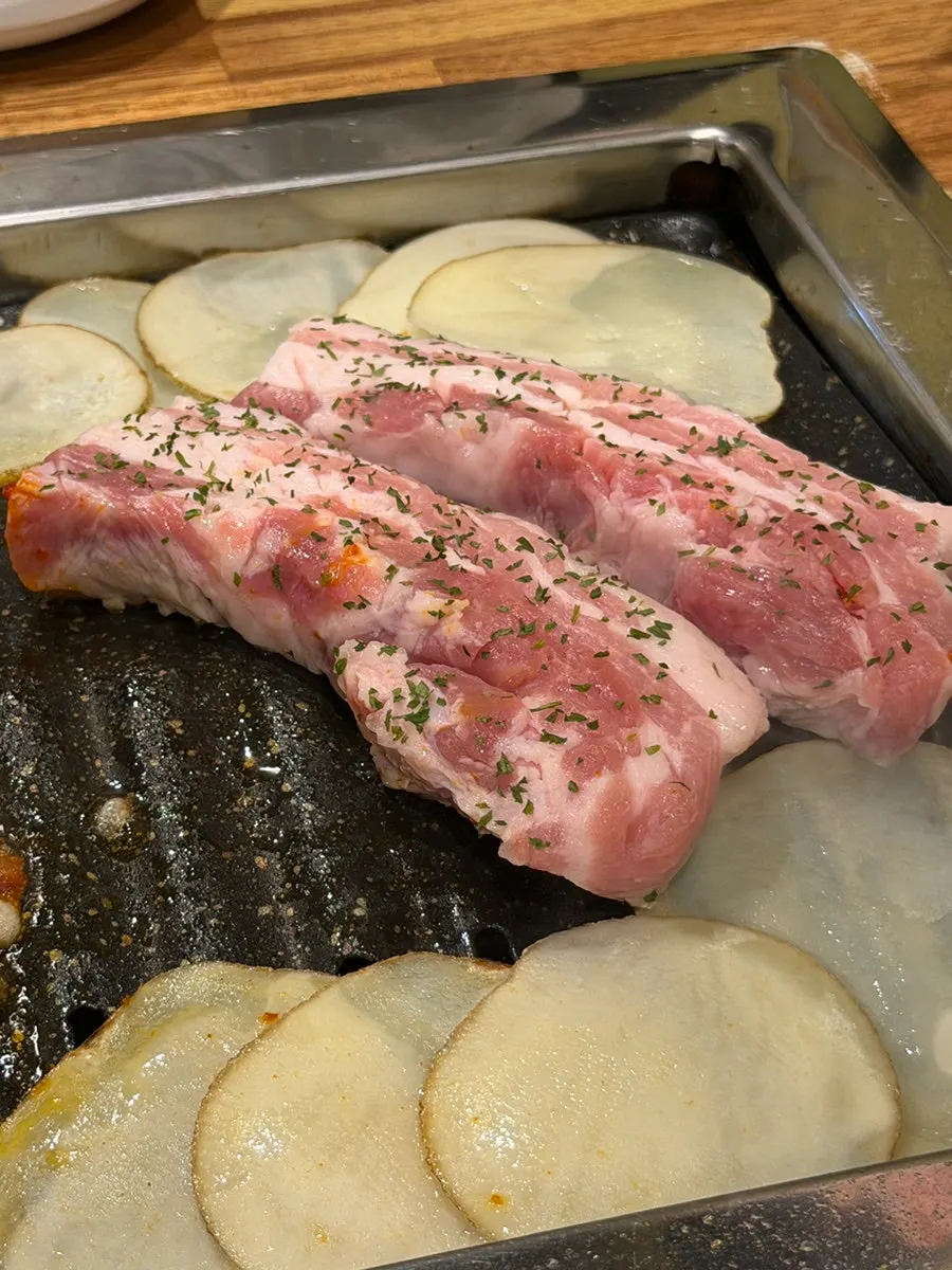 Pork belly grilled by a staff member