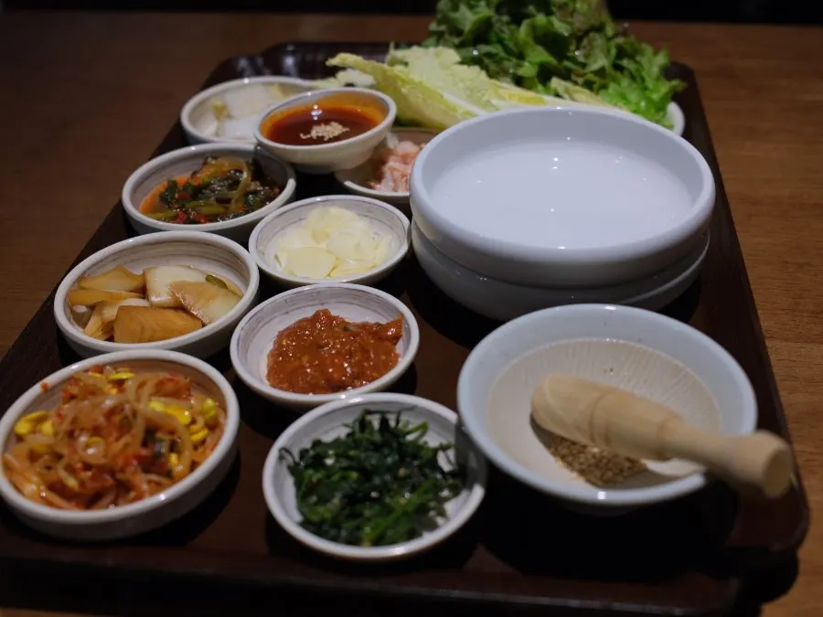 Basic spread of white kimchi and namul at Uldong Bossam