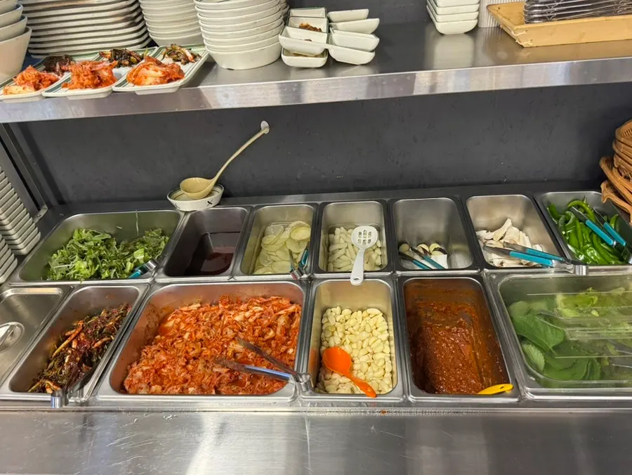 Self-serve bar with lettuce and kimchi at Suyeong Naengsam