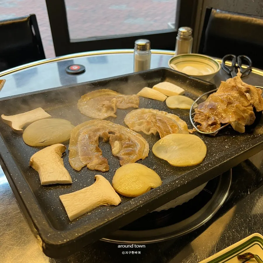 Potatoes and mushrooms grilled alongside the meat