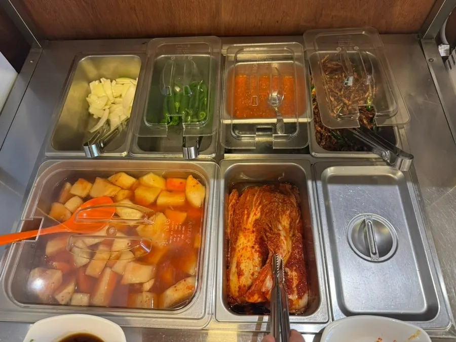 Self-serve bar with peppers, garlic, and ssamjang