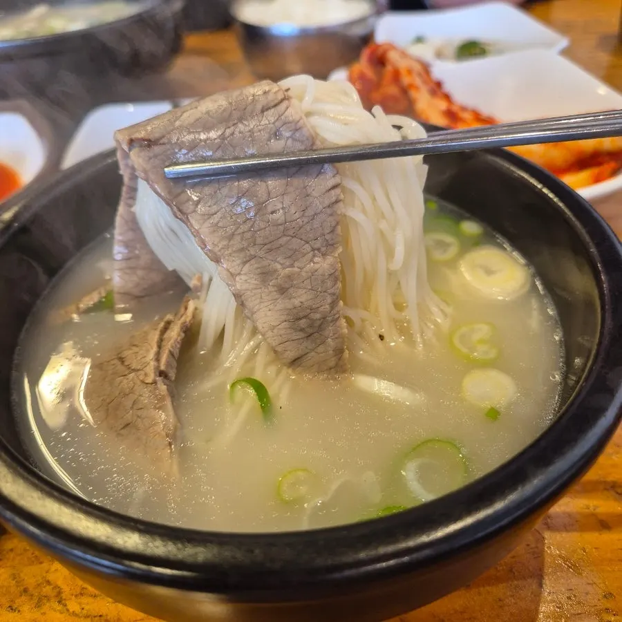 A bite of noodles and meat from the seolleongtang