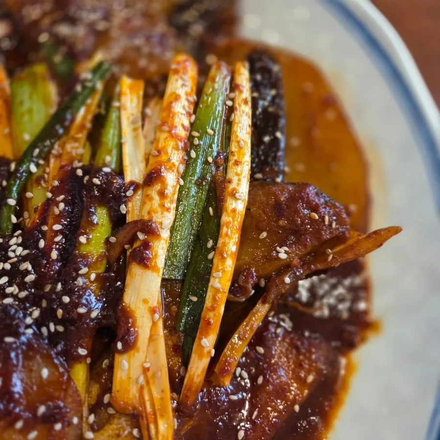 Sweet green onions included in the braised cod dish