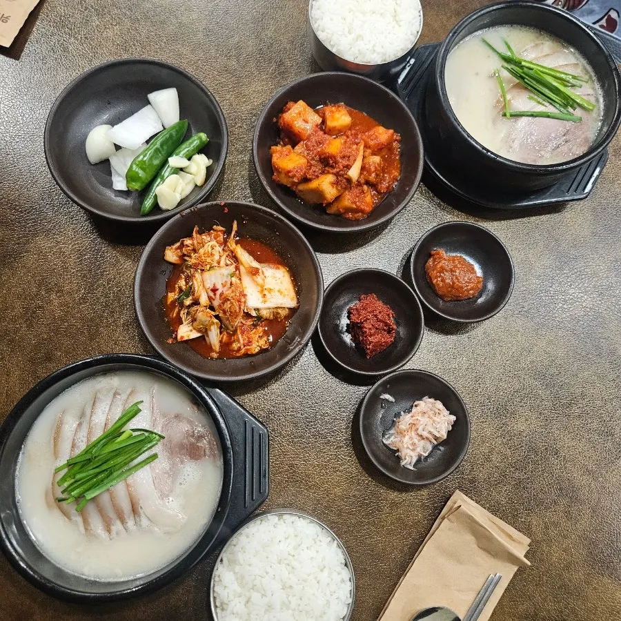 Pork gukbap topped with generous meat, served with a bowl of rice