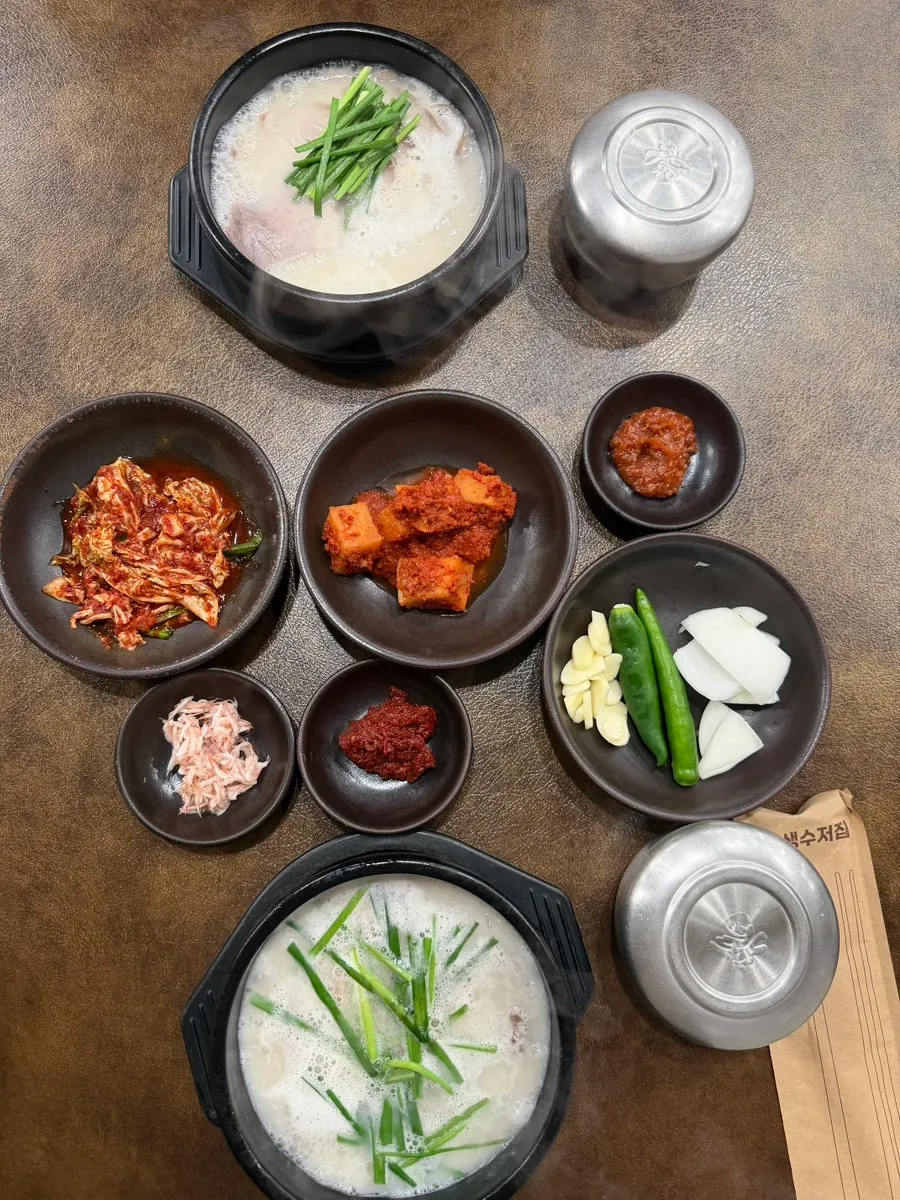 Full table setting of gamasot pork gukbap