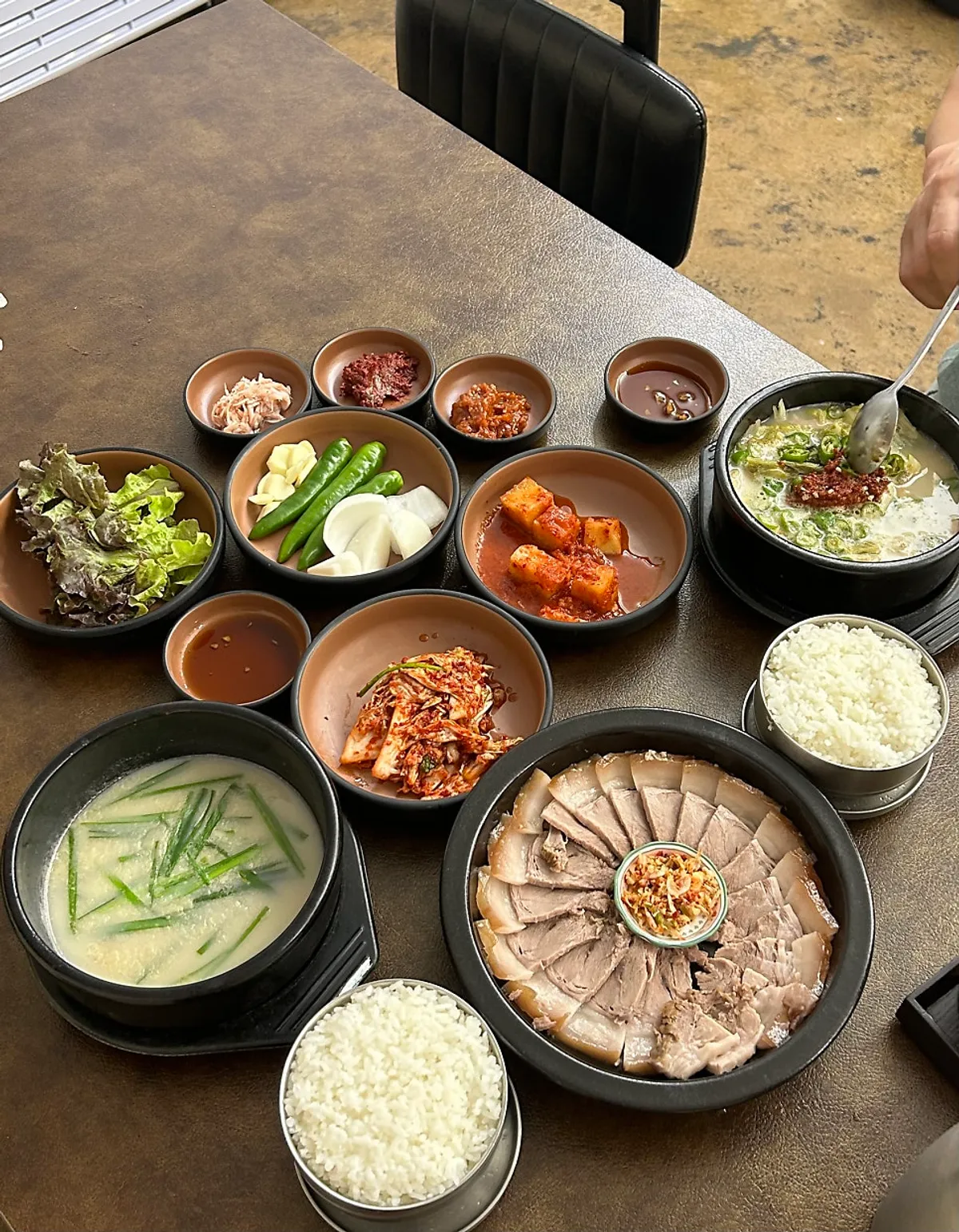 Table set with the boiled pork set and spicy gukbap