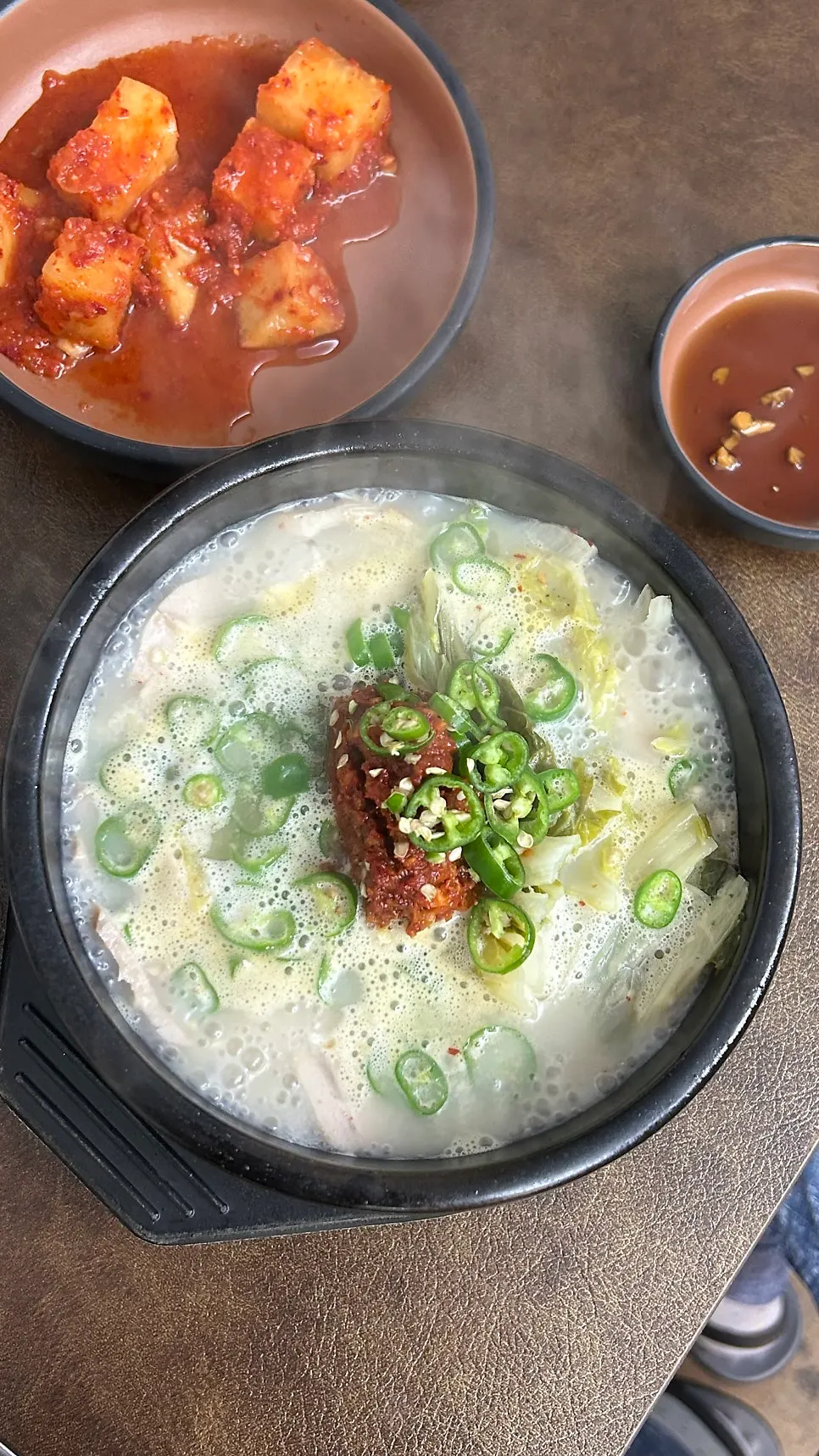 A bowl of spicy gukbap topped with spicy seasoning