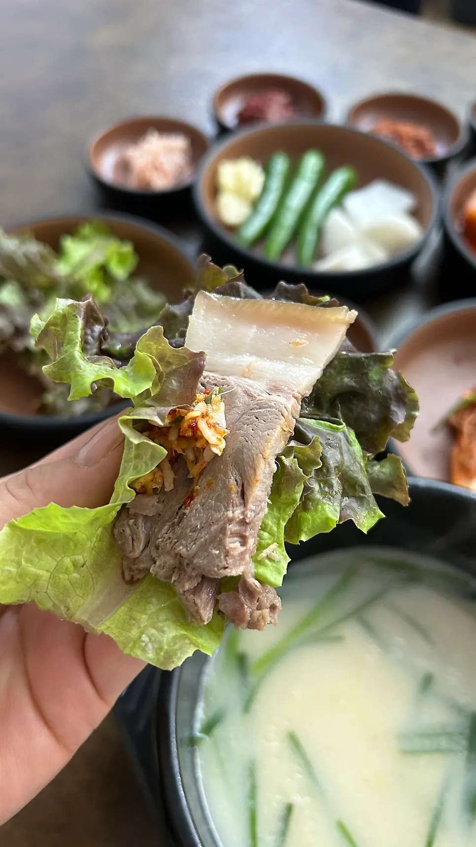 A piece of boiled pork dipped in mustard sauce