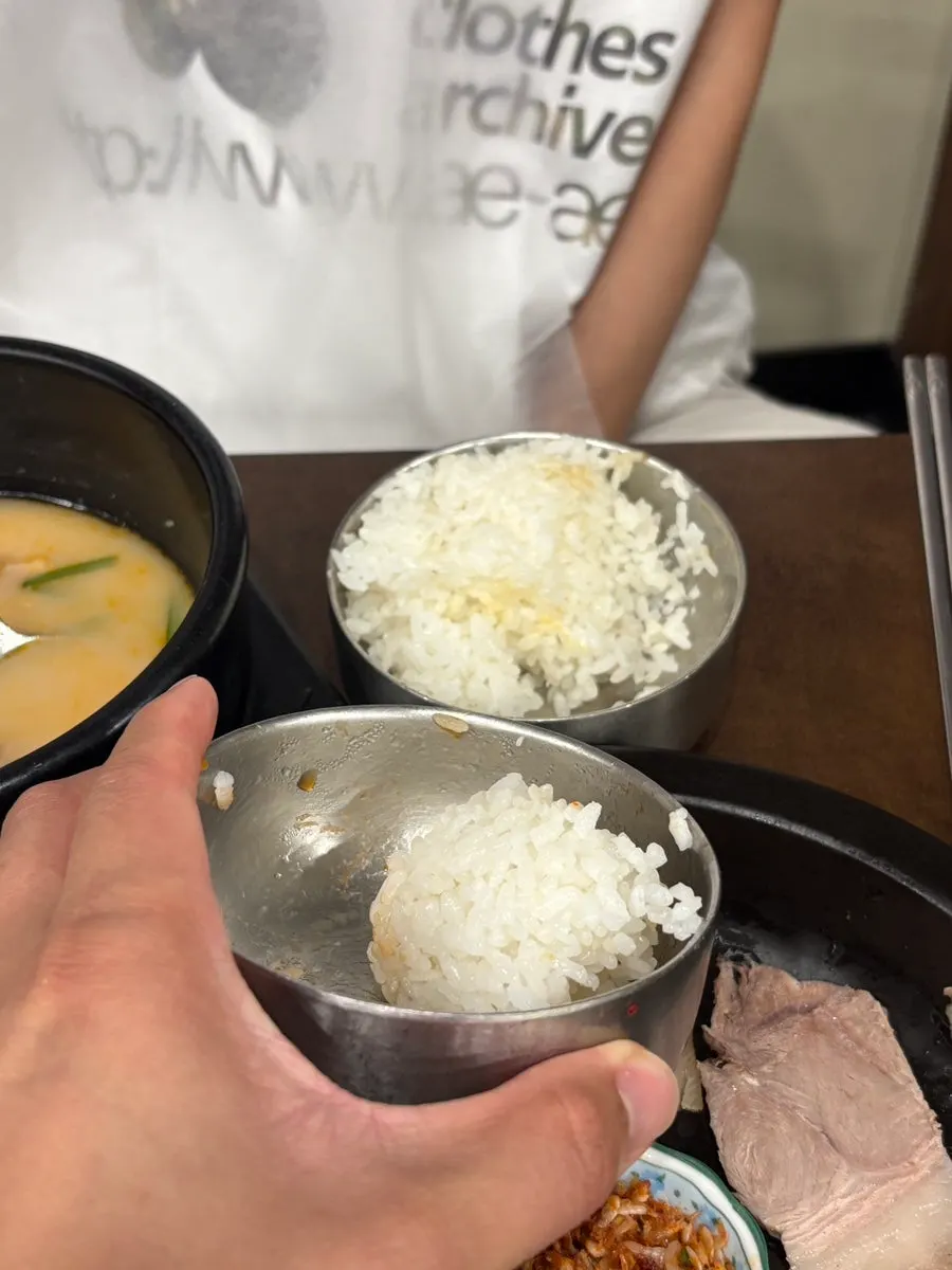 A couple sharing rice and suyuk at the table