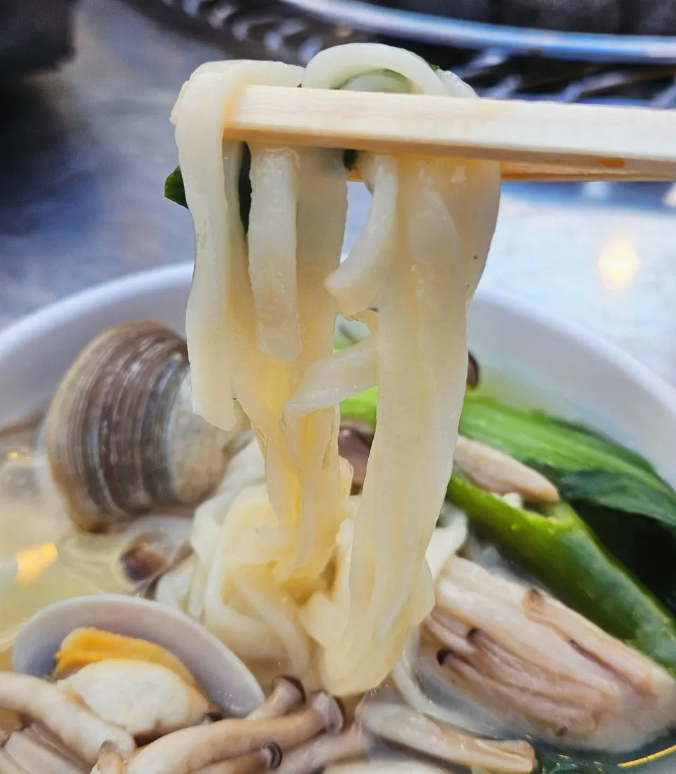 Nampo's shabu shellfish noodle soup simmering