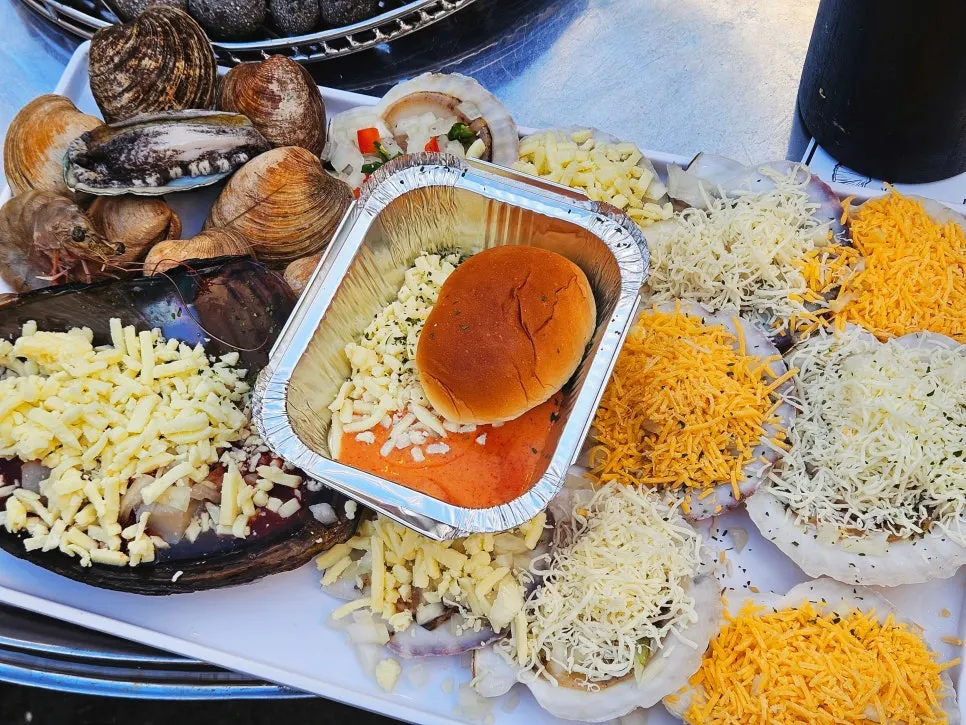 A full pan of Nampo's medium shellfish grill topped with cheese