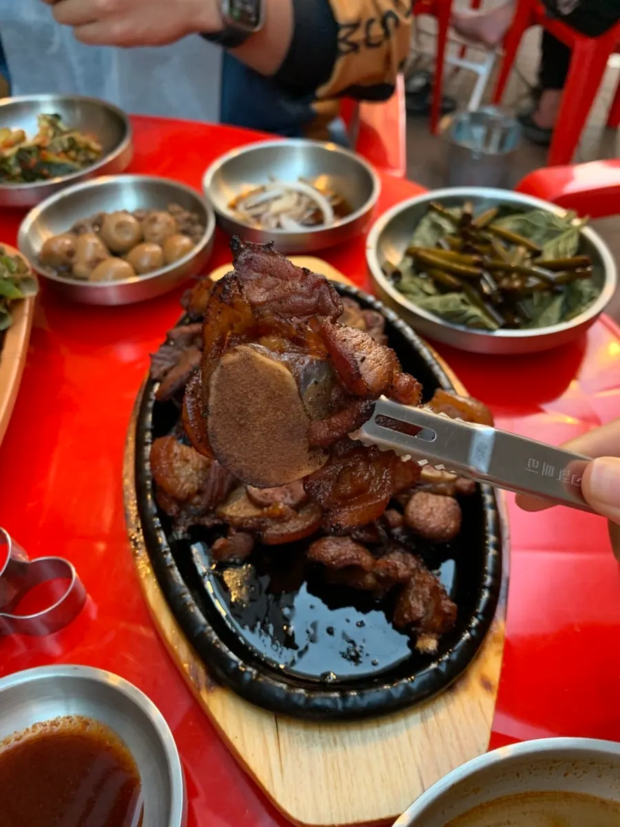Black pork wrapped in a lettuce leaf