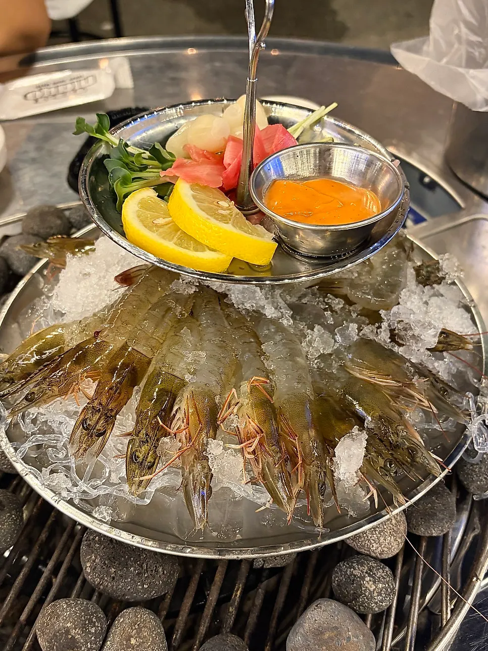 A plate of raw shrimp sashimi served on ice