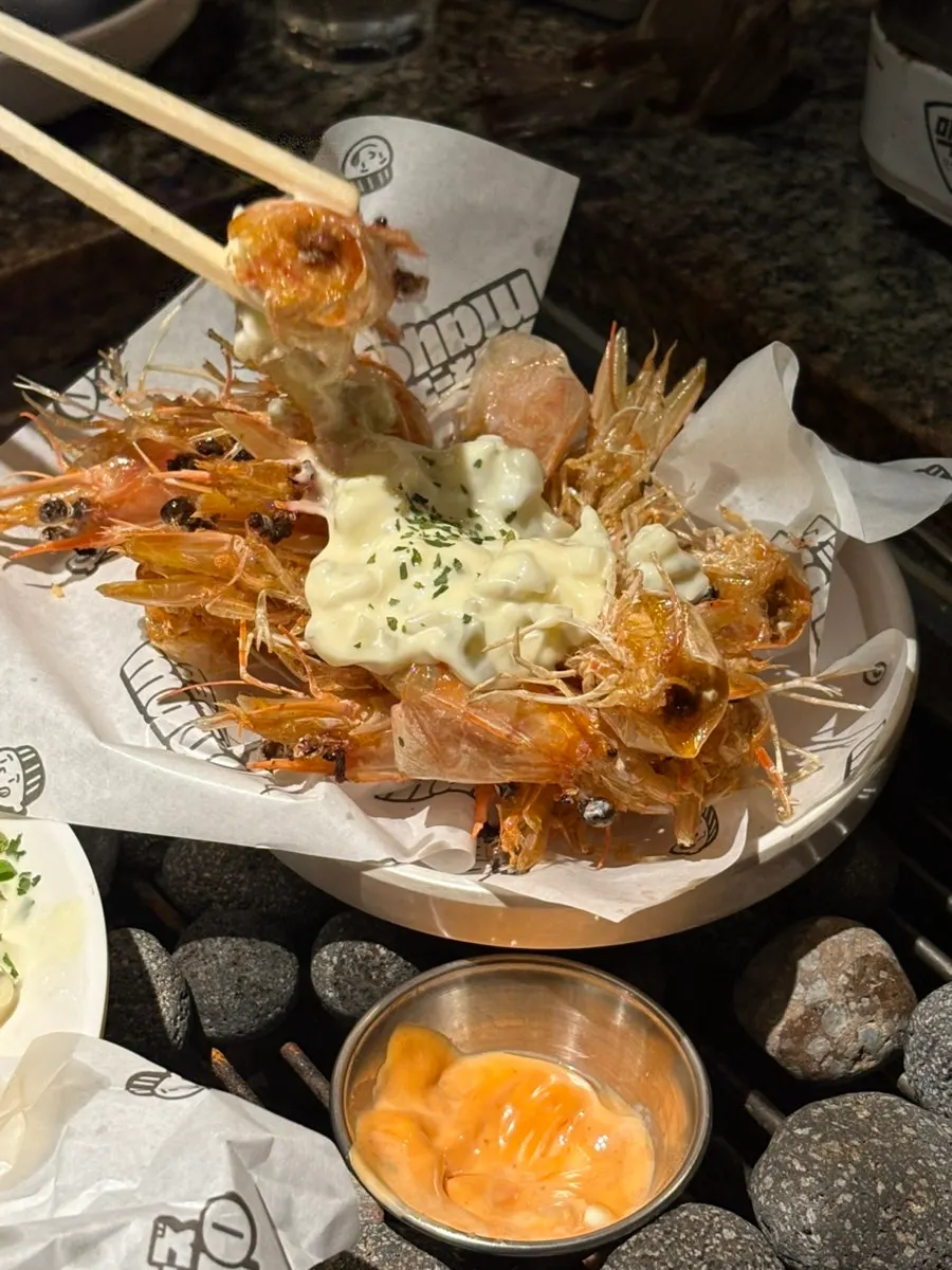 Crispy fried shrimp heads topped with sauce