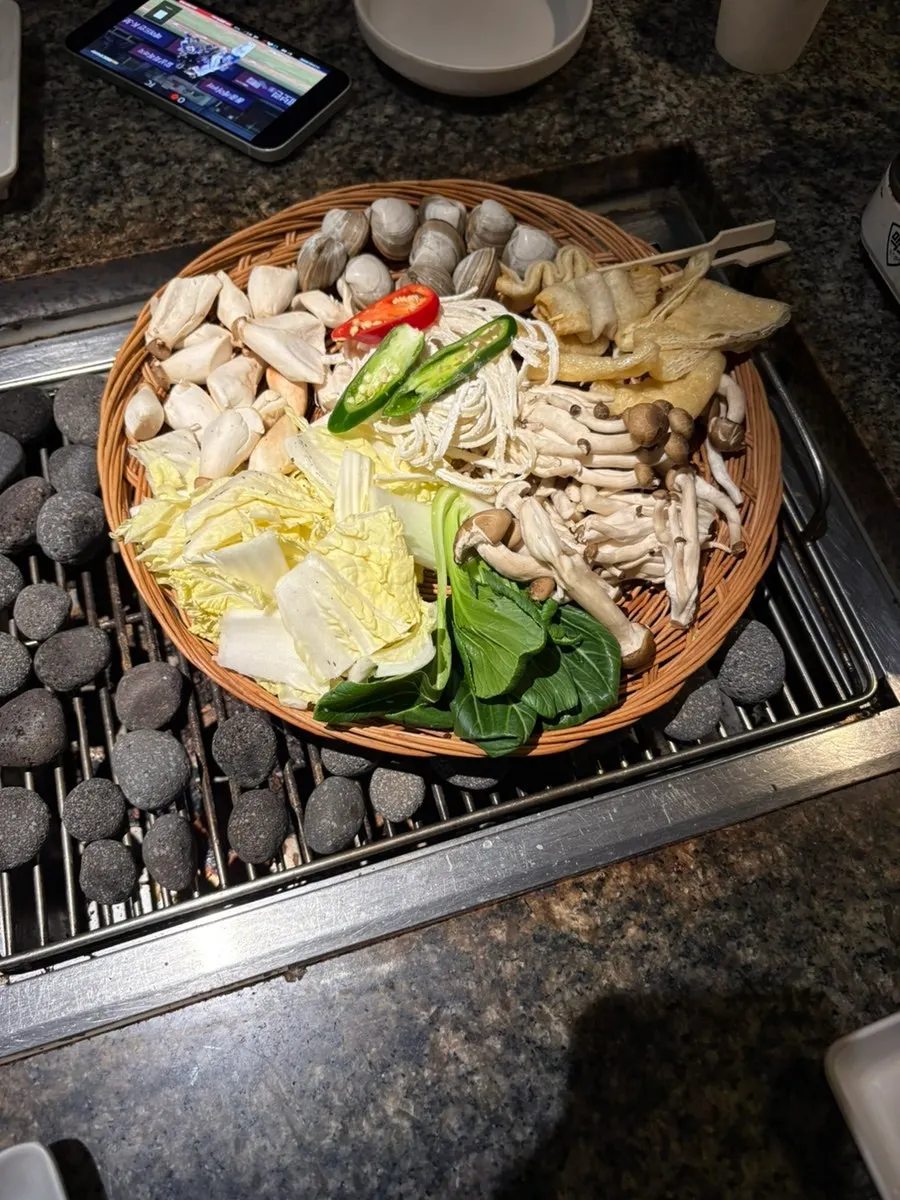 Basket of vegetables, fish cake, and noodles for shabu-shabu