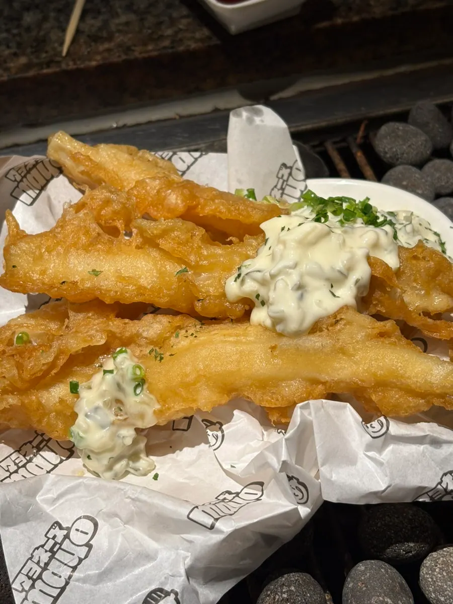Plate of fried squid topped with sauce