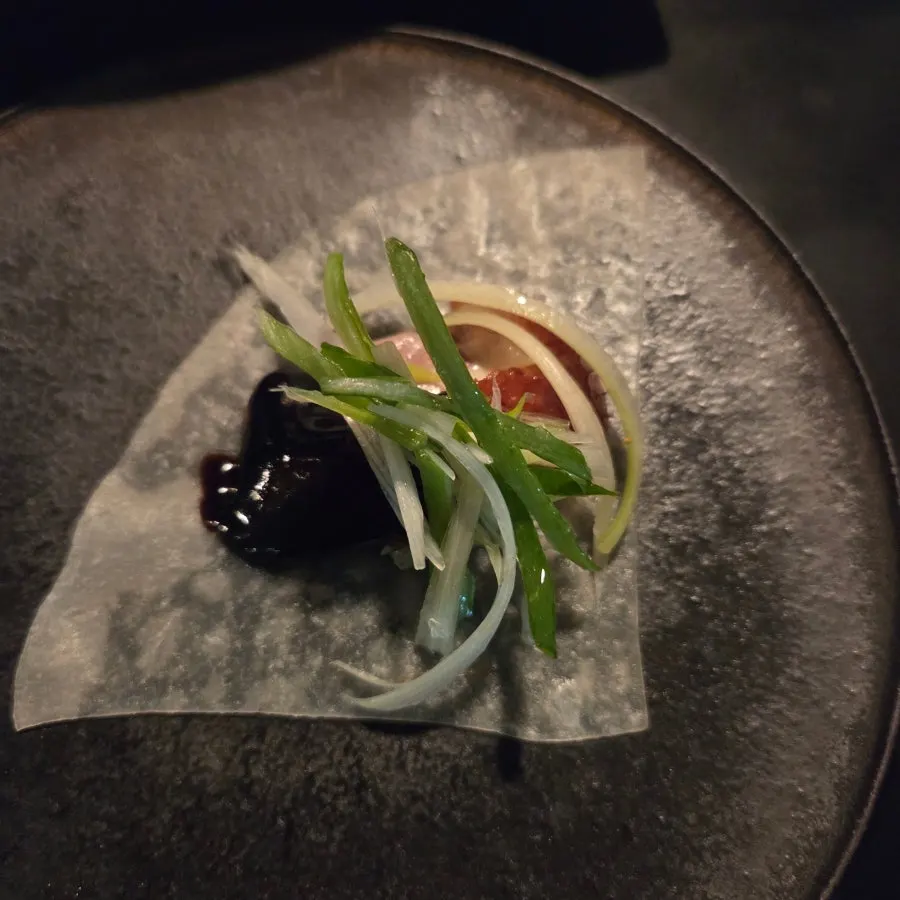Wrapping Peking duck in a wheat pancake