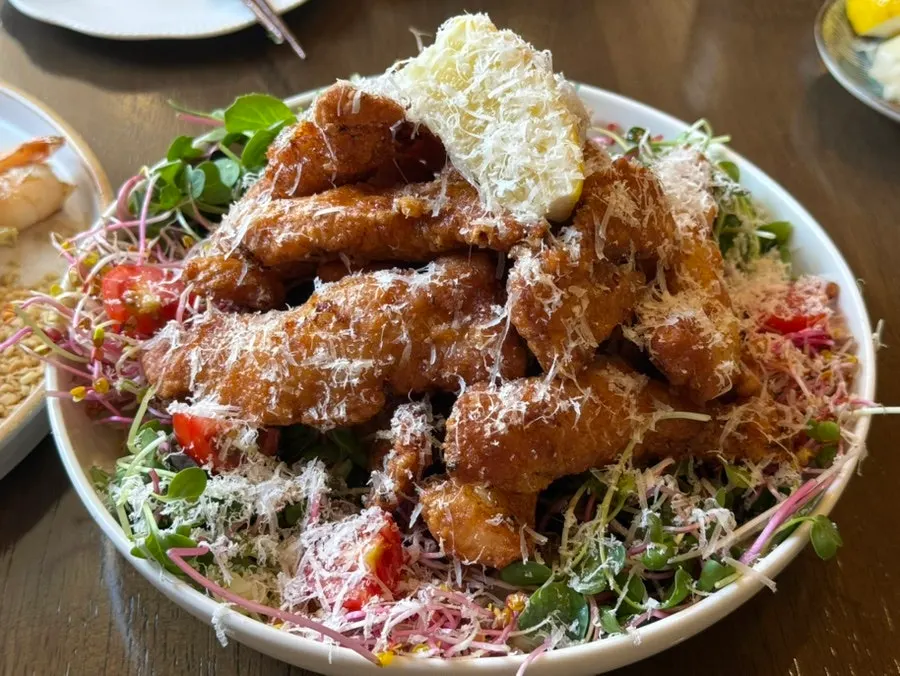 Kai phrai chicken salad topped with cheese