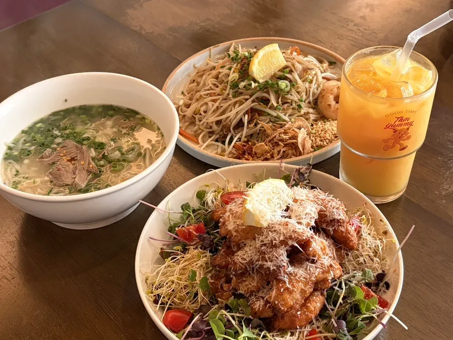 Table with pad thai, kai phrai, and pho