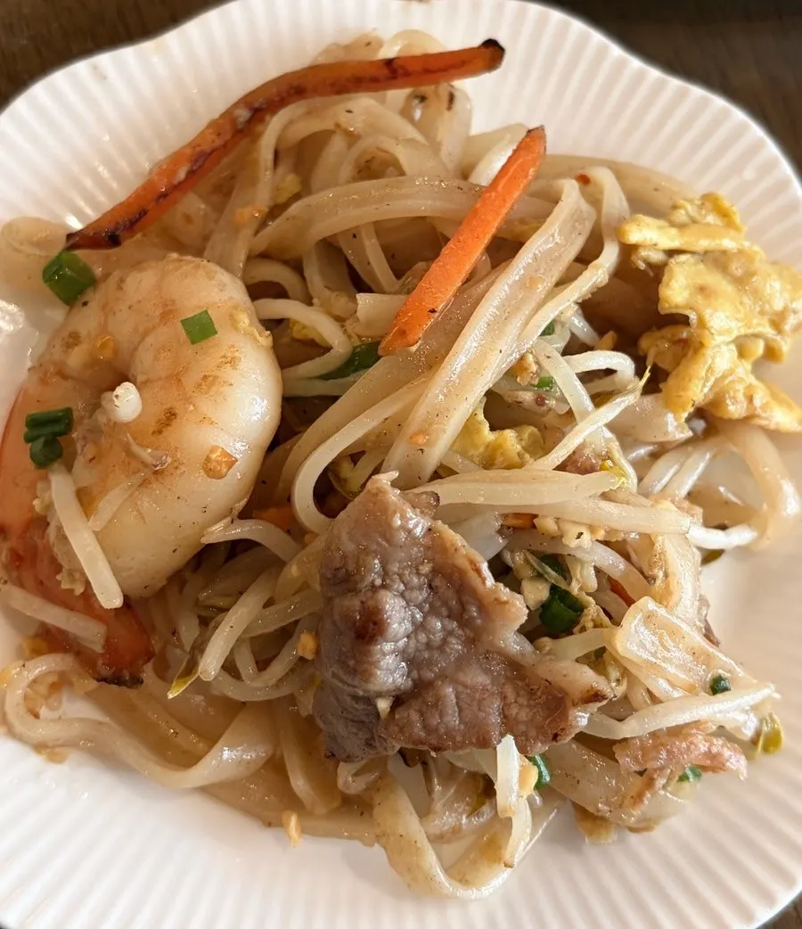 Close-up of pad thai mixed with crushed peanuts and bean sprouts