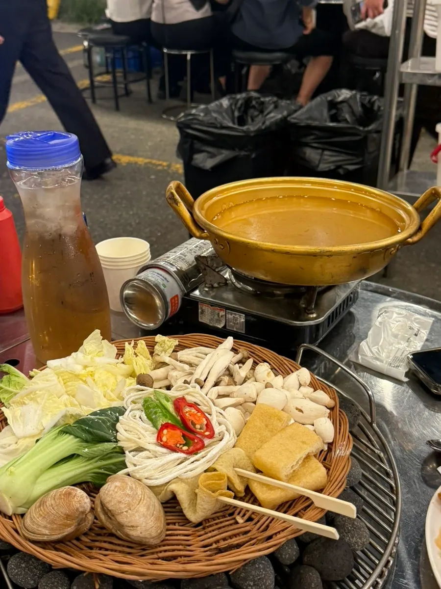 Ingredients simmering in broth for the fish-cake clam soup